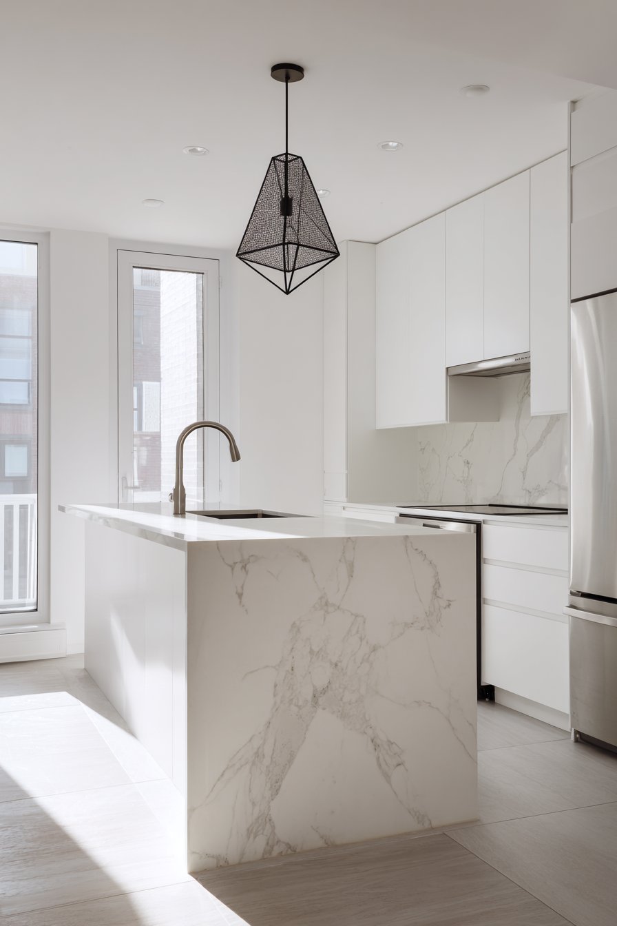 Seamless White Cabinet Kitchen with Waterfall Island