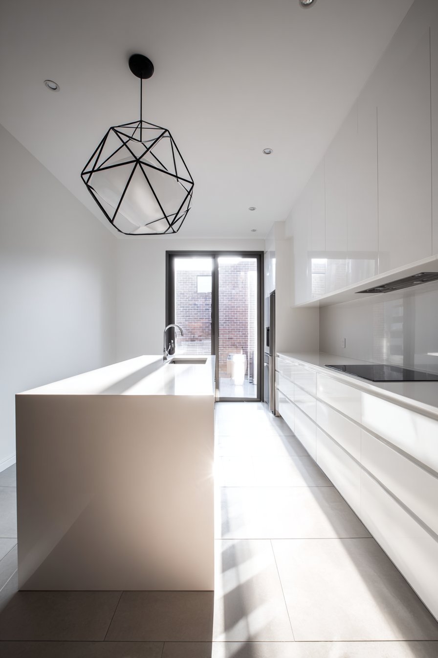Seamless White Cabinet Kitchen with Waterfall Island