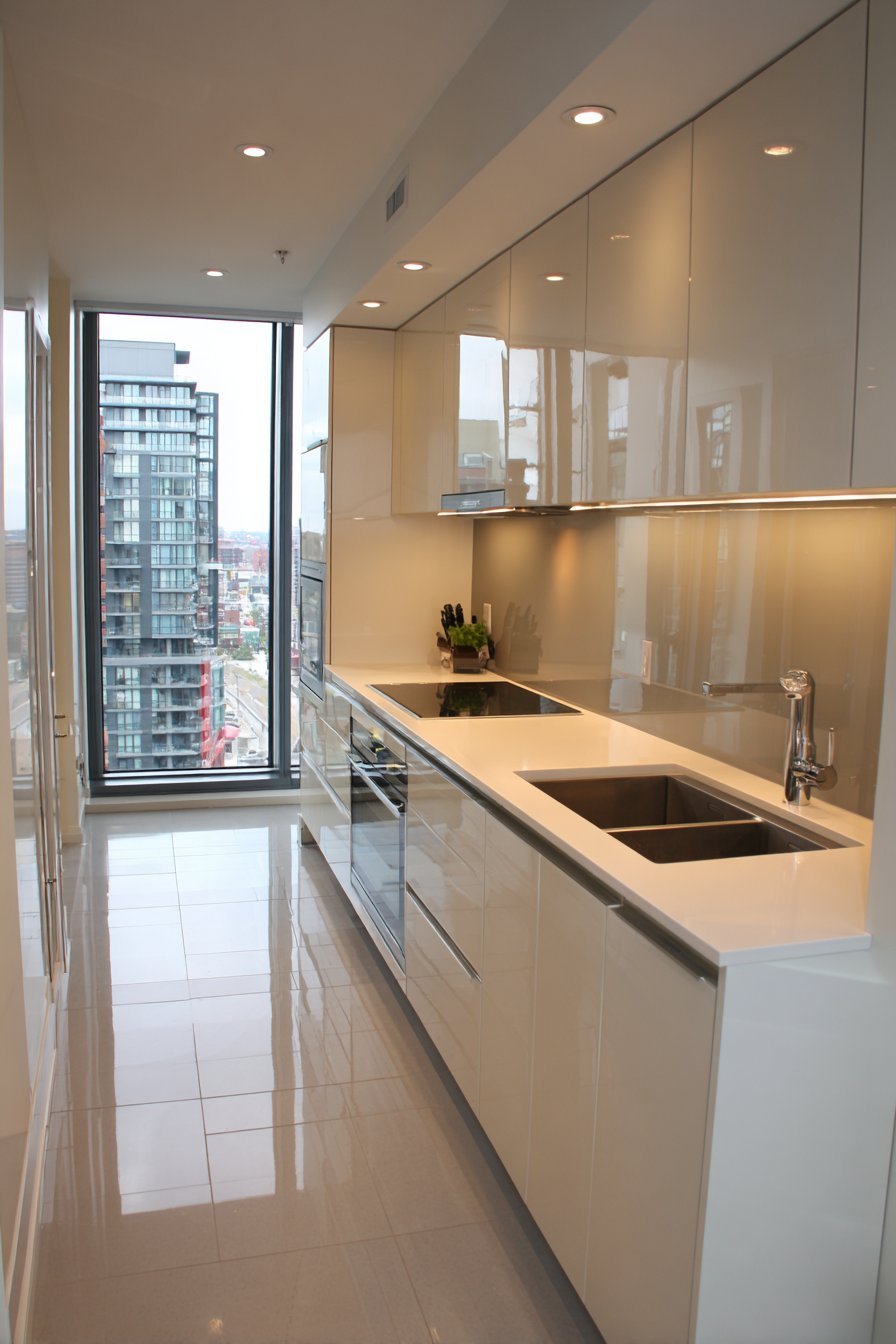 High-Gloss White Galley with Glass Backsplash
